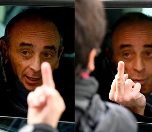 Eric Zemmour zeigt einer Passantin den Stinkefinger