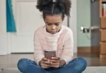 Zwischen Kontrolle und Realität – Frankreichs Debatte um das Handyverbot an Schulen Kind_Smartphone